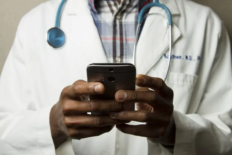 Healthcare professional reviewing patient data on digital tablet